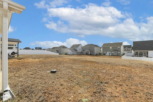 view of yard featuring a residential view and fence