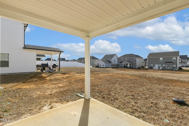 view of yard featuring a patio area and a residential view