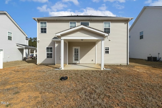 rear view of property featuring central AC and a patio area