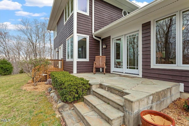 exterior space with a patio and a lawn