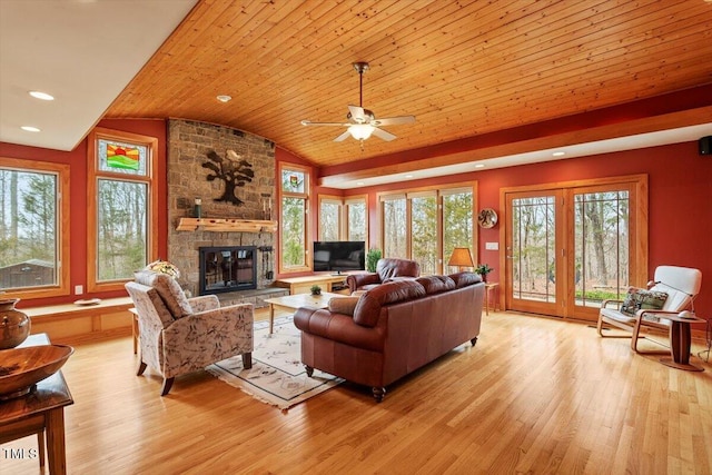 living room featuring a stone fireplace, wood ceiling, lofted ceiling, and light wood-style floors