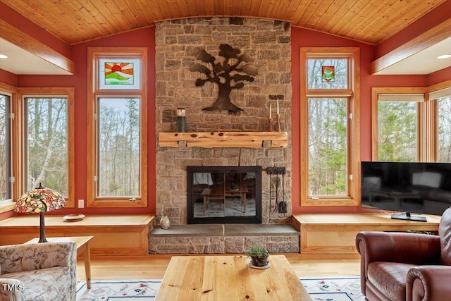 living area featuring vaulted ceiling, wood finished floors, and wood ceiling