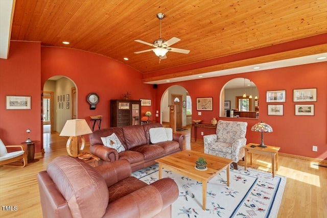 living room with baseboards, lofted ceiling, arched walkways, light wood-style floors, and wood ceiling