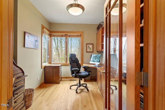 home office featuring light wood finished floors and baseboards