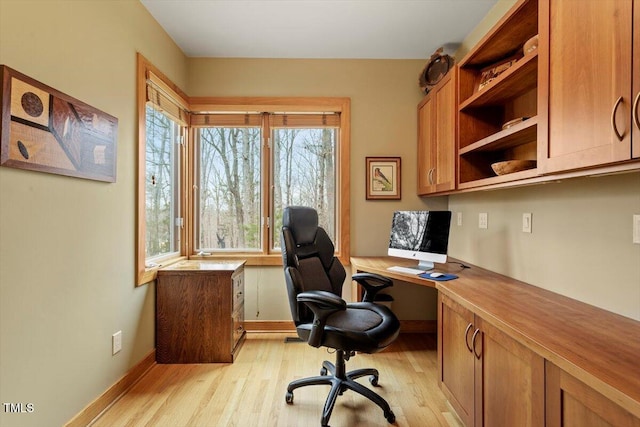 office featuring baseboards and light wood-style floors