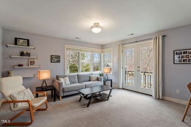 living area featuring visible vents, carpet flooring, french doors, and baseboards