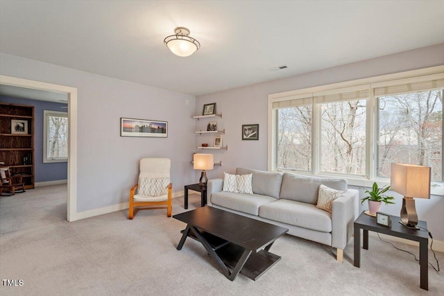 living room featuring baseboards, plenty of natural light, light colored carpet, and visible vents