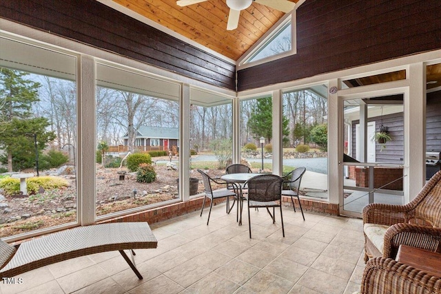 sunroom / solarium with wooden ceiling, a ceiling fan, and vaulted ceiling