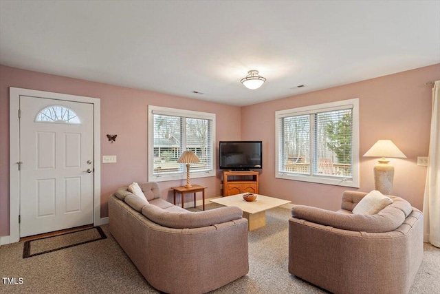 carpeted living room with visible vents and baseboards