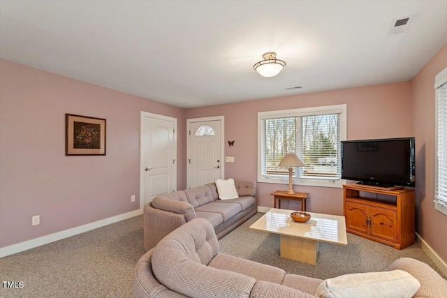 carpeted living room with visible vents and baseboards