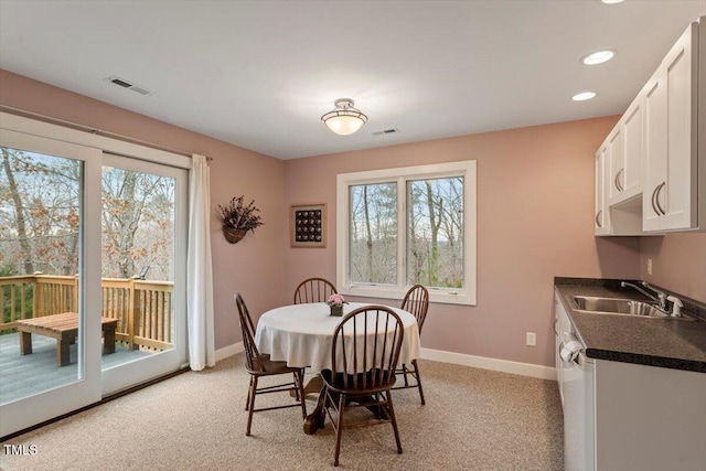 dining room featuring visible vents, baseboards, and a wealth of natural light