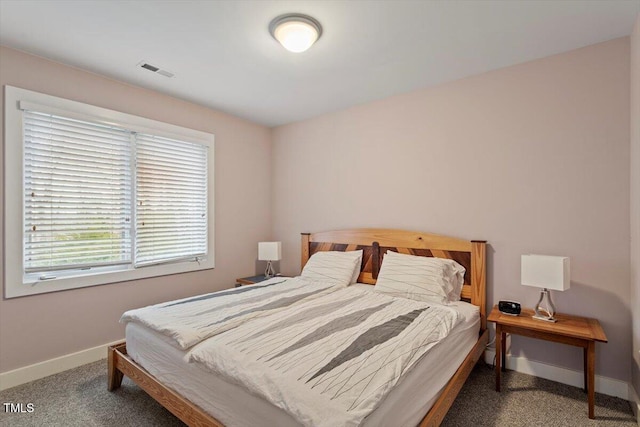 carpeted bedroom with baseboards and visible vents