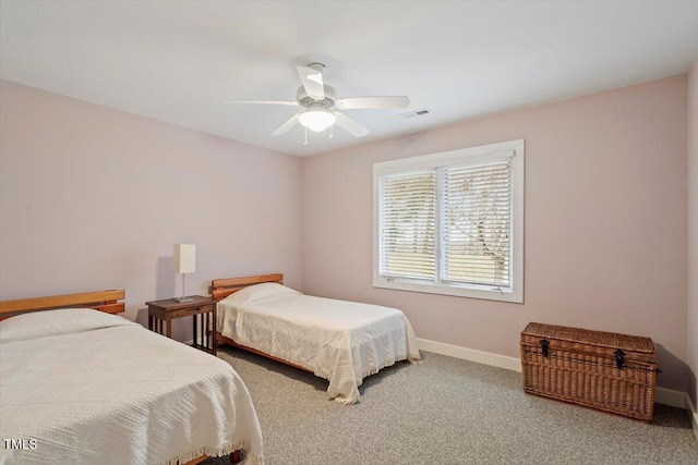 bedroom featuring visible vents, baseboards, carpet, and a ceiling fan