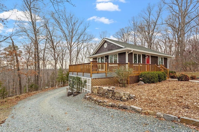 view of front of property featuring gravel driveway and a deck