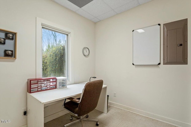 office area with electric panel, tile patterned floors, a paneled ceiling, and baseboards