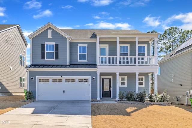 view of front of house featuring a standing seam roof, covered porch, concrete driveway, metal roof, and a garage