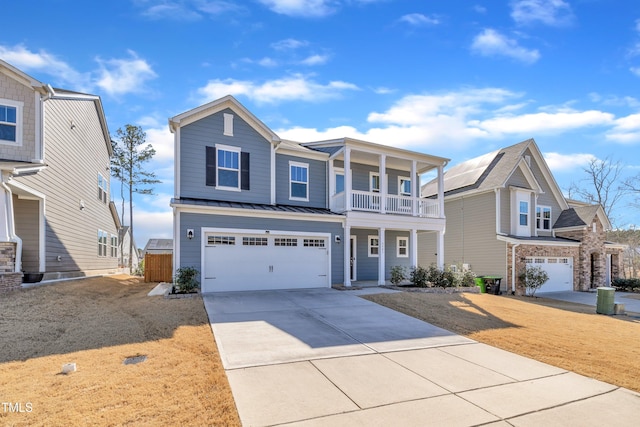 view of front of property featuring driveway, a standing seam roof, metal roof, a garage, and a balcony