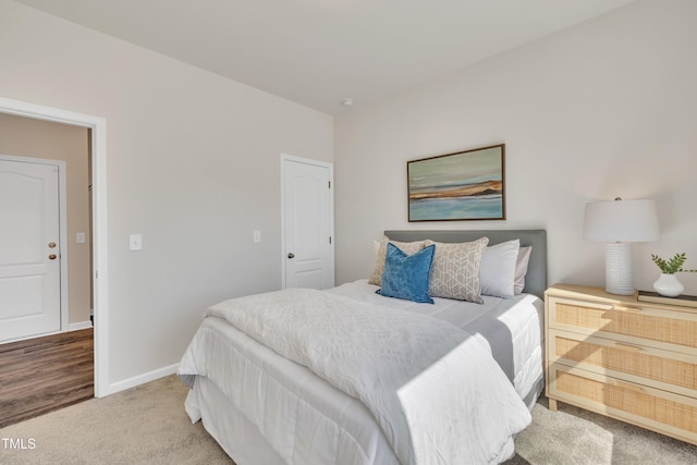 carpeted bedroom featuring baseboards