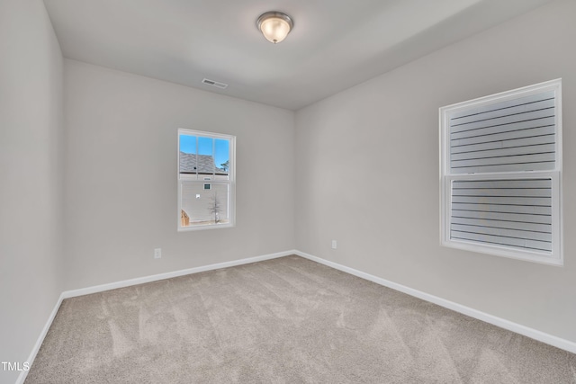 spare room featuring visible vents, baseboards, and carpet floors