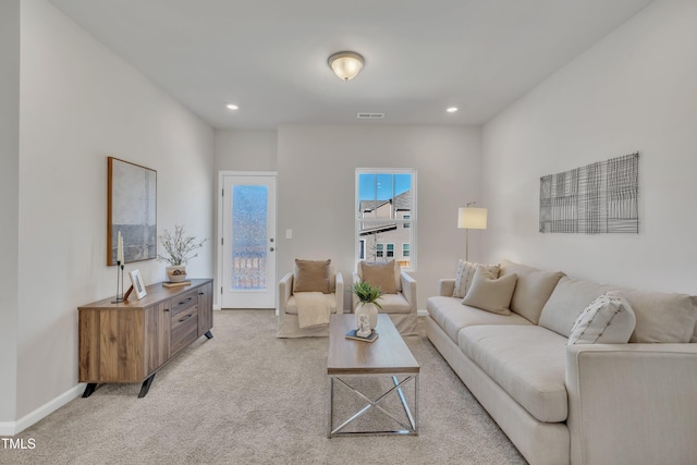 living room featuring light carpet, visible vents, recessed lighting, and baseboards