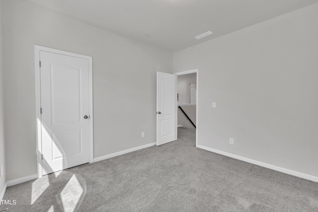 unfurnished bedroom featuring visible vents, carpet, and baseboards