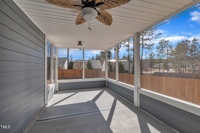 unfurnished sunroom featuring ceiling fan