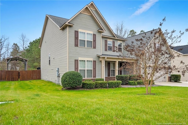 craftsman-style home with a garage, a front lawn, driveway, and fence