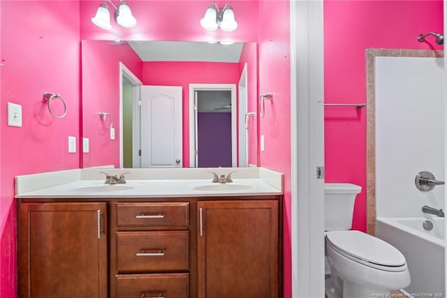 full bath with double vanity, toilet, shower / washtub combination, and a sink