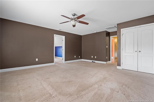 unfurnished bedroom featuring visible vents, carpet floors, baseboards, and a ceiling fan