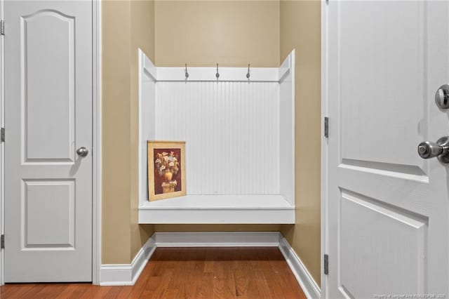 mudroom featuring baseboards and wood finished floors