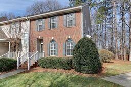 view of front of property with brick siding and a chimney