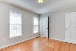 unfurnished bedroom with baseboards and wood finished floors