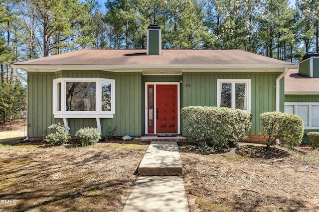 view of front of home featuring board and batten siding and a chimney