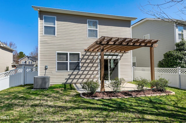 rear view of house with a fenced backyard, central AC unit, a pergola, and a yard