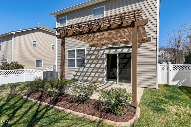 back of house with a pergola, a patio, a fenced backyard, cooling unit, and a yard