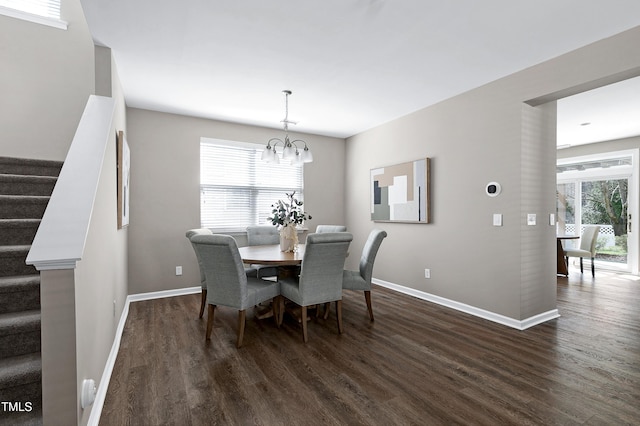 dining space with stairway, a notable chandelier, dark wood-style floors, and baseboards