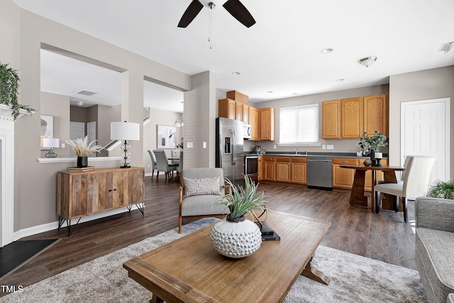 living area featuring dark wood-style floors, visible vents, and baseboards