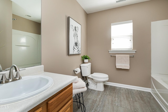 full bathroom with visible vents, baseboards, toilet, a tub to relax in, and vanity