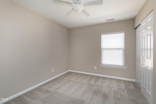 unfurnished bedroom featuring visible vents, light carpet, baseboards, and a closet