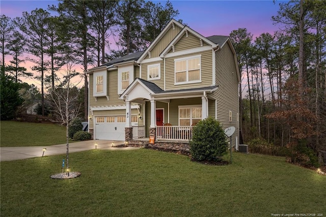 craftsman-style house featuring central air condition unit, driveway, a porch, a yard, and board and batten siding