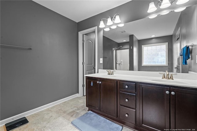 full bathroom with a sink, baseboards, a shower, and double vanity