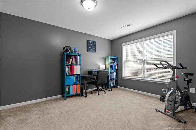 carpeted office with baseboards and visible vents