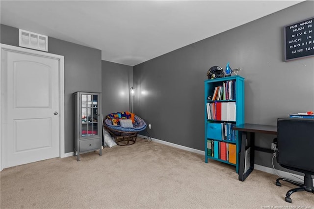 carpeted office space featuring visible vents and baseboards