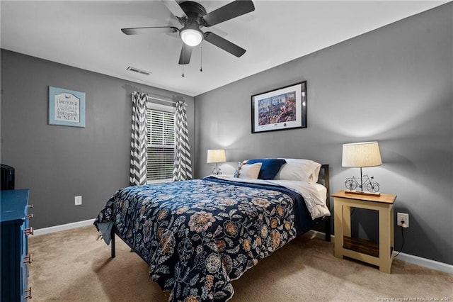 bedroom featuring visible vents, a ceiling fan, baseboards, and carpet floors