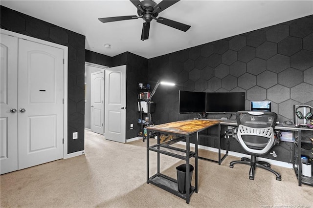 home office featuring light colored carpet, baseboards, and a ceiling fan