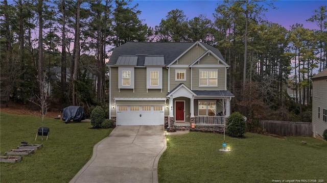 craftsman house featuring a garage, driveway, and a front lawn