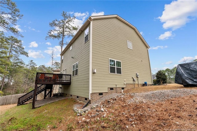 view of property exterior featuring stairs, a wooden deck, and crawl space