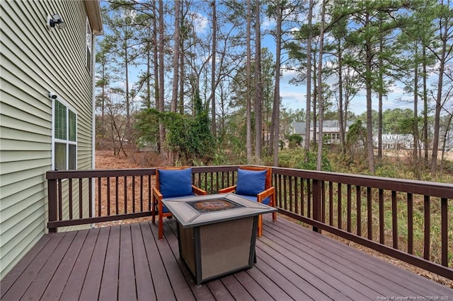 wooden terrace with a fire pit