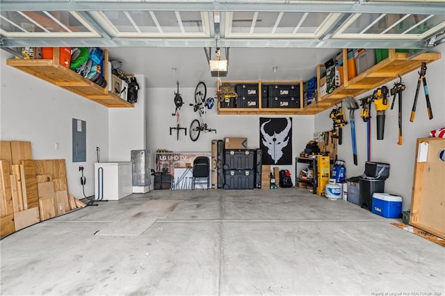 garage featuring electric panel and a garage door opener