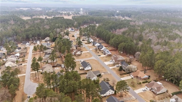 birds eye view of property with a view of trees and a residential view